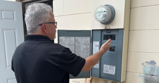 electrician inspecting electrical panel