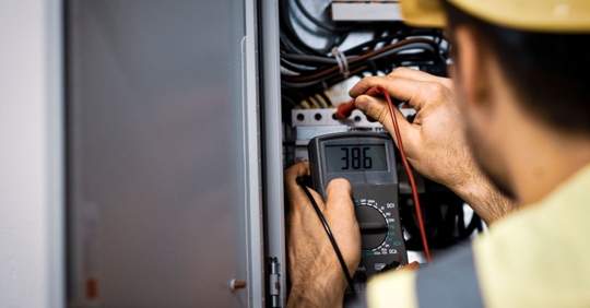man working on electrical panel