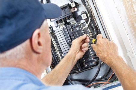 Electrician working on electrical panel